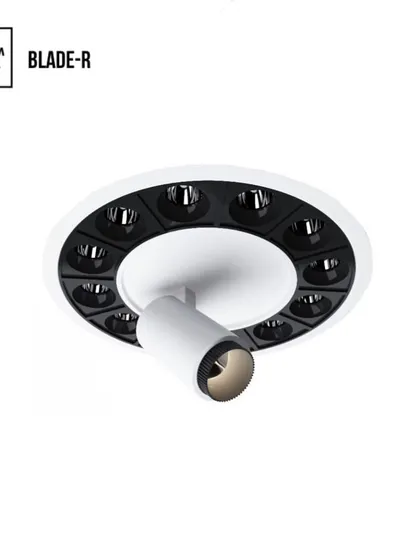 The Blade R is a new concept developed for architectural integration. This version features a central spotlight surrounded by a ring of recessed downlights, offering both focused and ambient light from one fixture.