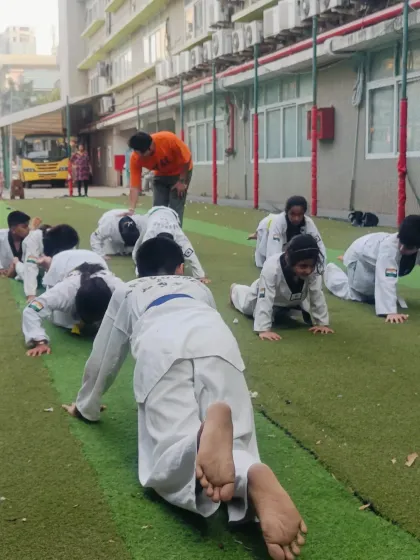 I supervise the students during their strength conditioning, ensuring proper form and providing encouragement to help them push through the challenge.