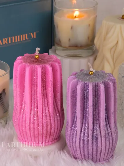 These ribbed pillar candles, shown here in pink and purple with a touch of glitter, are perfect for adding a bit of sparkle to your space.