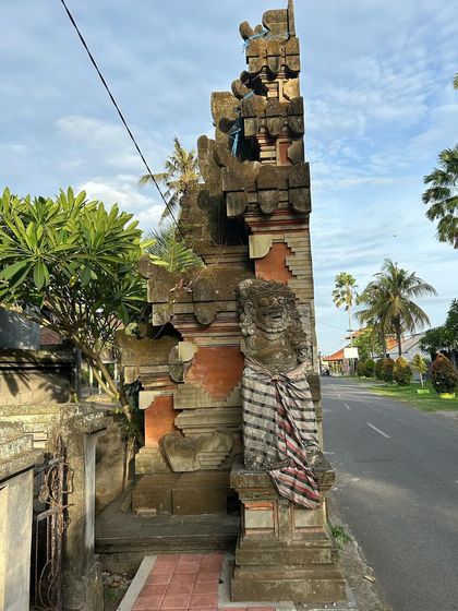 The weathered stone and intricate carvings of this traditional Balinese gate tell a story of centuries of cultural exchange and artistic evolution.