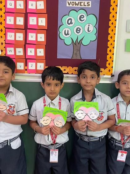 A group of boys proudly displays the cards they made for Grandparents Day. We celebrate family connections and teach our students the importance of expressing love and respect.