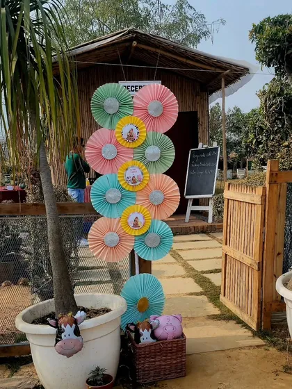 The entrance to the party venue, decorated with a colorful tower of paper pinwheels. This created a festive and welcoming first impression for the guests.