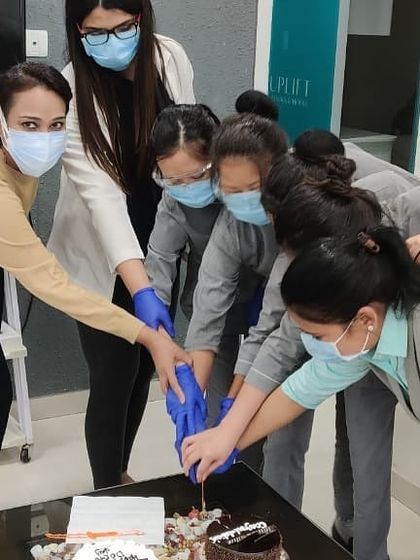 A team effort to cut the Doctor's Day cake! It reflects how we work together in everything we do at the clinic.