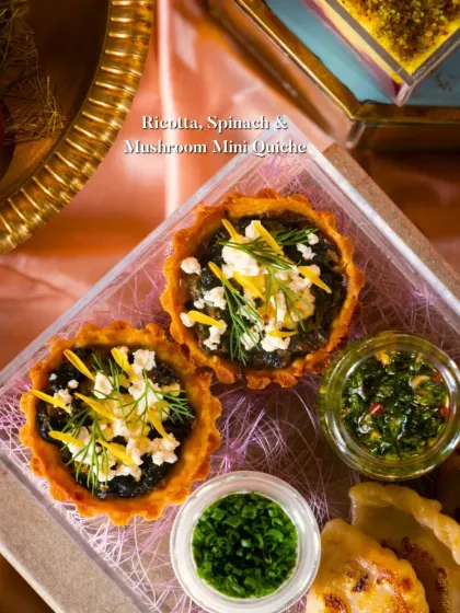 A close-up of my Ricotta, Spinach & Mushroom Mini Quiche. These savory bites are perfect for cocktail parties and events, featuring a flaky crust and a rich, flavorful filling, garnished with fresh dill and cheese.