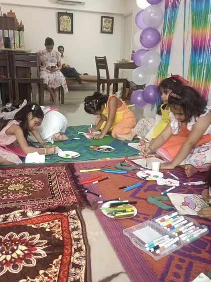 The full setup for our tote bag painting party. You can see the kids completely absorbed in their work, which gives parents a chance to relax and mingle.