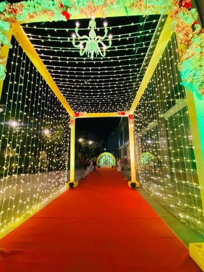 Looking through the illuminated entrance tunnel, with the yellow-lit arches creating a beautiful frame.