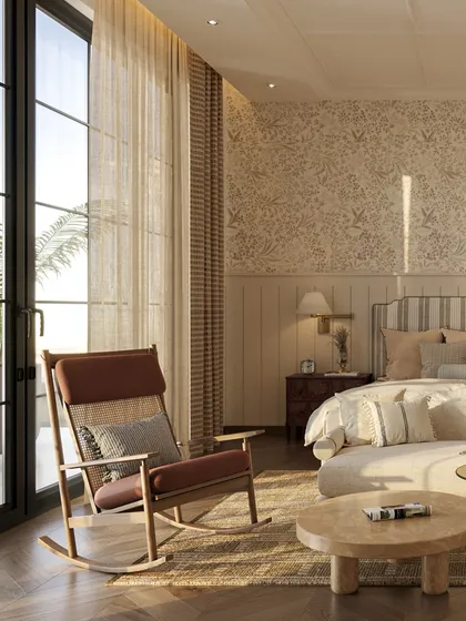 The rocking chair is perfectly positioned by the large window, creating a peaceful corner for reading and relaxing. The room is filled with warm, natural light.