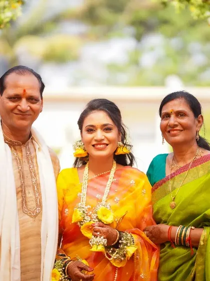 A precious family portrait with the bride during her Haldi. Her bright smile, flanked by her proud parents, makes for a beautiful memory.