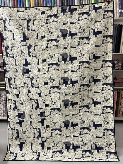 The back of the Bear Paw quilt, with a subtle black and white print.
