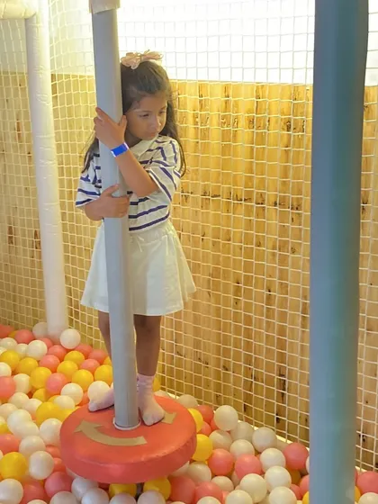 A child having fun on one of the spinners in the ball pit during a Paw Patrol themed birthday party.