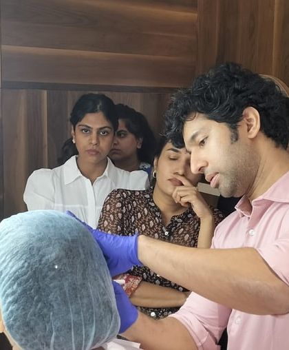 A close-up of a hands-on thread lift demonstration. My goal when training other doctors is to impart the precision and artistry required to use these tools for effective facial contouring and rejuvenation.