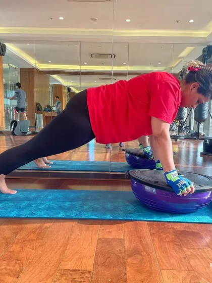 A client holds a perfect plank on a BOSU ball, an exercise that significantly increases core engagement. A strong core is essential for preventing injury and improving athletic performance.