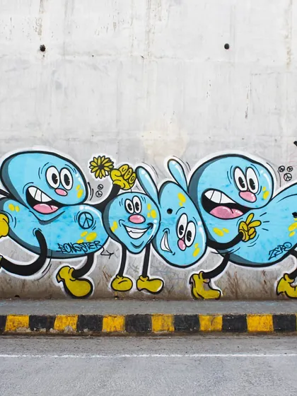 A fun, cartoon-style piece with a message of peace. This shows my versatility in creating more playful and accessible characters for public walls.