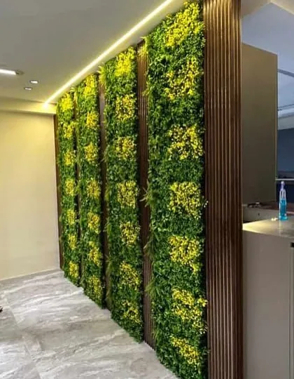 Bring the outdoors inside with an indoor vertical garden. This installation in a commercial space adds a touch of nature and sophistication. These panels are a great solution for covering plain walls and require no watering or sunlight.