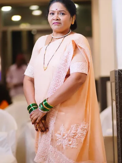 A full-length view of the client's look, showing how the makeup and peach saree come together beautifully.