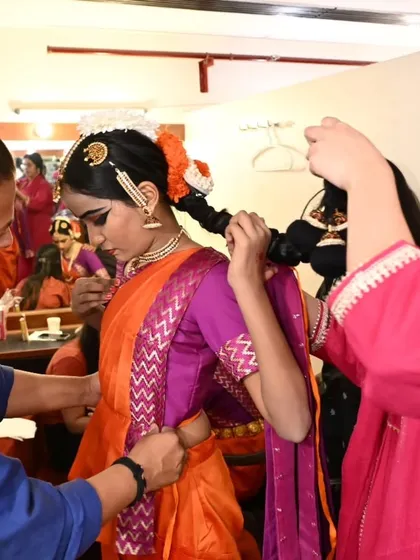 Backstage at our 'Abhyaas' showcase is a learning experience for everyone. Here, senior students and teachers help the younger shishyas with their costumes, a beautiful example of our dance family supporting each other.