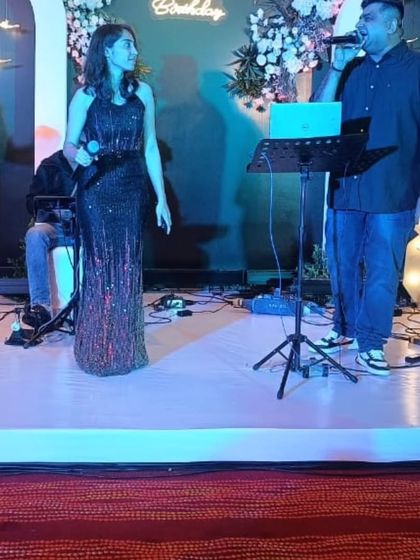 A closer look at our singers engaging with each other during a live performance. Their on-stage chemistry helps create a lively and entertaining atmosphere for all your guests.