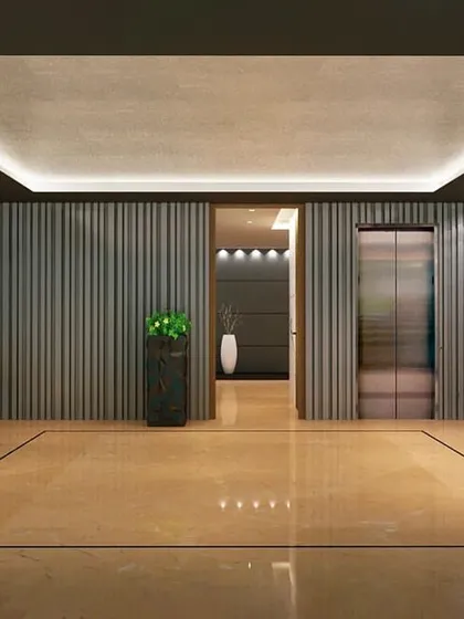 The lobby entrance for Embrace Towers, designed with tailor-made lifestyle amenities in mind. The interior features vertically ribbed walls and polished marble floors, setting a tone of modern luxury from the moment of entry.