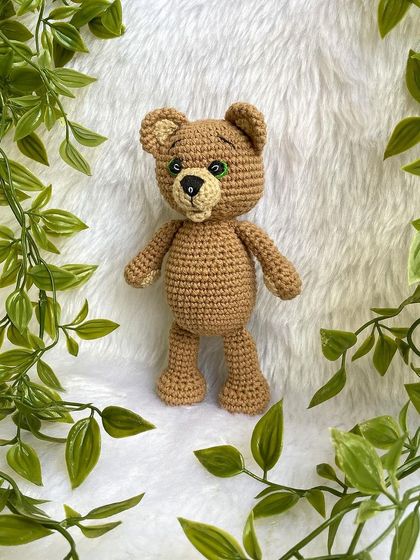 A classic teddy bear, a timeless gift for any age. This one is shown with a red ribbon, a black tie for 'Daddy Bear', and with expressive green eyes. They are soft, cuddly, and made to be loved.