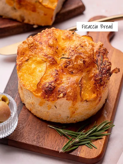 My freshly baked Focaccia Bread, with a cheesy, golden-brown crust and infused with rosemary. It's perfect on its own or for dipping.