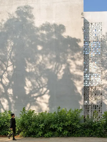 At Vidyashilp Academy, the play of light and shadow through traditional 'jali' screens is more than an aesthetic choice; it's a passive cooling strategy. This image captures the human-centric scale of our work, where every detail is designed to enhance the user's sensory experience and well-being.