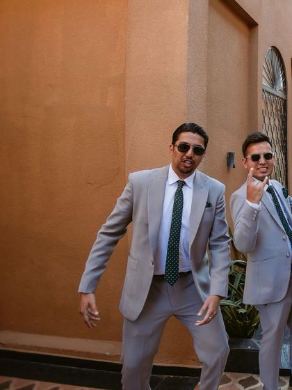 A candid shot of one of the groomsmen, full of personality and fun, enjoying the celebration.