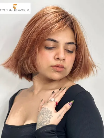 A haircut can be a statement. This edgy copper brown bob with textured bangs is designed to frame the face and sharpen the jawline, delivering a fresh and fearless look.