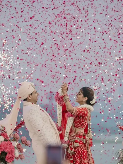 The peak of the varmala, with cold pyros and a shower of petals creating a truly spectacular moment. This is what a grand wedding celebration looks like.