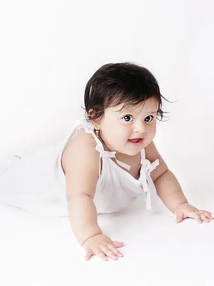 Sometimes the most beautiful portraits are the simplest. This classic, all-white setup lets this little one's sweet expression and curious eyes be the complete focus of the photograph.