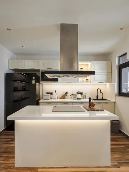 Another view of the kitchen from image 5, emphasizing the clean lines and functional layout.