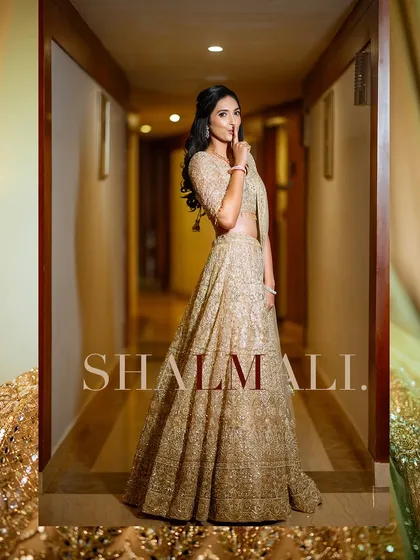 A stylish and playful portrait of the bride in a beautifully lit hallway.