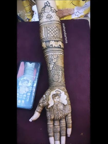 I often use a reference photo on my phone to ensure the groom's portrait is as accurate as possible, capturing his features in the henna.