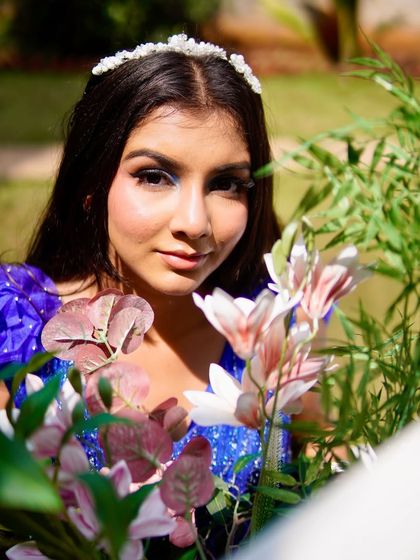 A closer look at the makeup for the blue gown shoot. You can see the subtle shimmer on the eyelids and the fresh, dewy skin finish, which was essential for this outdoor, natural light setting.