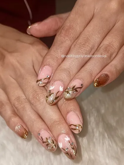 A full look at the hand-painted floral and gold accent nails, showcasing the artistry and care that goes into each set.