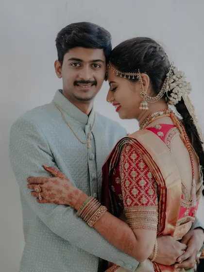 A romantic portrait of the couple. The bride's red quilted blouse adds a modern texture to her traditional South Indian wedding look.