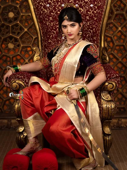 A full-length view of Sreeleela on the throne. This image emphasizes the grandeur of the entire setup, from the costume design to the set itself.