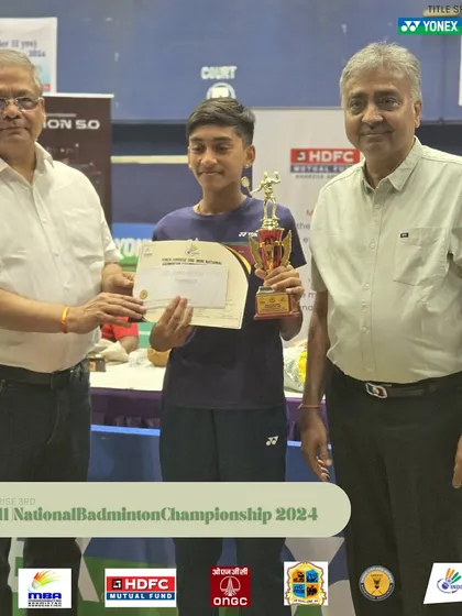 Another young winner being felicitated at the Mini National Badminton Championship.