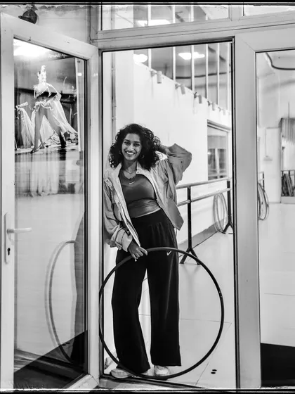 Eshna, a hoop dancer, in her studio. This portrait captures her passion and the joy she finds in her craft.