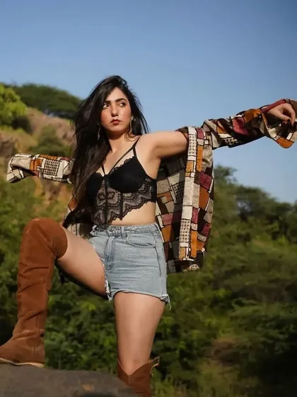 A powerful pose in my outdoor shoot look, showing how to style layers for a dynamic outfit.