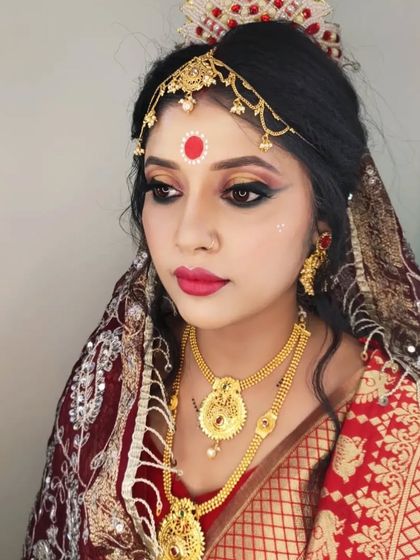The complete look with the traditional mukut (crown) and bold eye makeup.