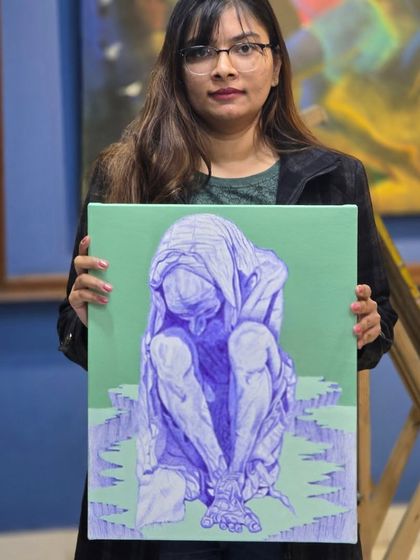 The finished piece. A student proudly holds her completed ballpoint pen figure drawing, a testament to her hard work in our life study workshop.