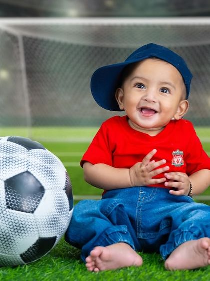 A close-up of our little Liverpool fan, with a huge smile that shows his love for the game.