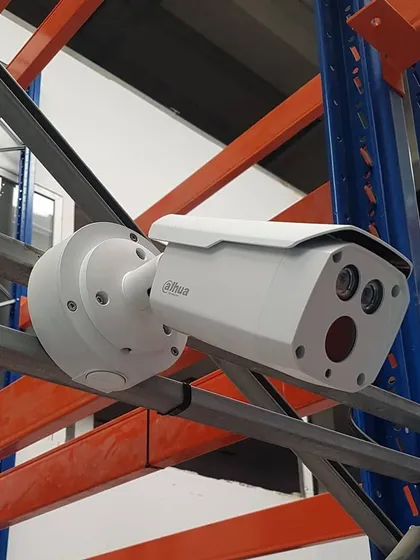 For warehouses and industrial spaces, we mount cameras directly onto racking and structural beams. This Dahua camera is positioned to monitor inventory and loading areas effectively.