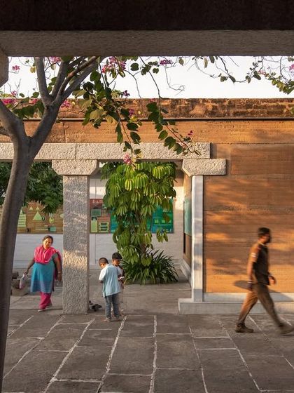 Visitors walking through the stone-paved courtyard of the science center. I design public buildings to be durable, welcoming, and inspiring for all who use them.