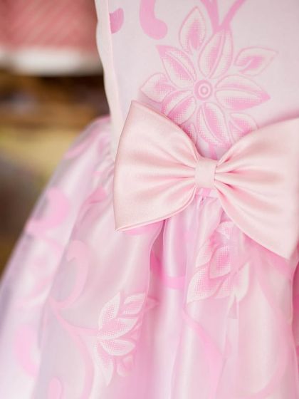 A detailed look at the tone-on-tone floral jacquard fabric I used for this pink dress. The matching satin bow adds a focal point and enhances the dress's texture.