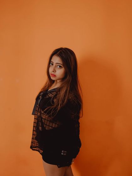 A simple yet striking portrait against a solid color background. This technique makes the subject the undeniable focus of the image.