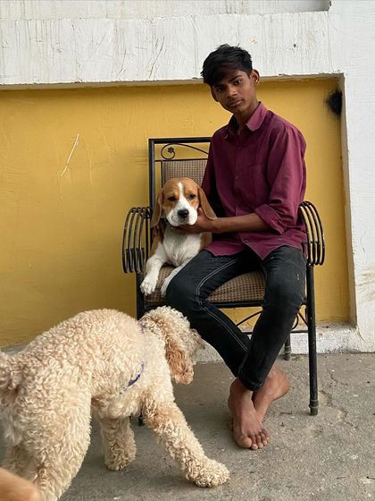 Kiwi posing with one of our staff members. He's a very photogenic dog.