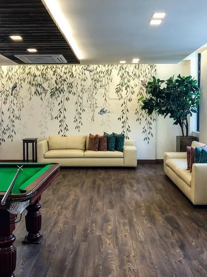 This is a games room I designed, complete with a pool table. The hand-painted weeping willow mural creates a serene and beautiful backdrop for a space that's all about fun and relaxation.