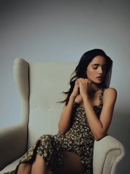 A pensive moment captured during the shoot. The understated makeup allows the model's expression and the overall mood to be the focus.