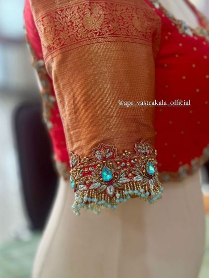 A close-up of the sleeve cuff, with delicate tassels and stone work.